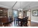 Cozy dining room featuring hardwood floors, a large window and modern lighting fixtures at 526 Sabal Trail Cir, Longwood, FL 32779