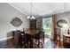 Cozy dining room featuring hardwood floors, a large window and modern lighting at 526 Sabal Trail Cir, Longwood, FL 32779