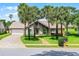 Charming home featuring palm trees, a brick driveway and walkway, and a well-maintained lawn at 526 Sabal Trail Cir, Longwood, FL 32779