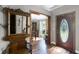 Inviting hallway with hardwood floors and views into the dining space and the foyer at 526 Sabal Trail Cir, Longwood, FL 32779