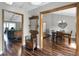 Inviting hallway with hardwood floors, antique mirror, and views into the dining and living spaces at 526 Sabal Trail Cir, Longwood, FL 32779