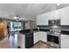 Kitchen with stainless steel appliances, granite countertops, and access to the backyard via sliding glass doors at 526 Sabal Trail Cir, Longwood, FL 32779