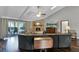 Comfortable living room with vaulted ceilings, brick fireplace, hardwood floors, and sliding glass doors leading to the backyard at 526 Sabal Trail Cir, Longwood, FL 32779