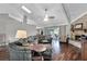 Bright living room with vaulted ceilings, brick fireplace, hardwood floors, and sliding glass doors leading to the backyard at 526 Sabal Trail Cir, Longwood, FL 32779