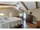 Main bedroom features hardwood floors, exposed beams, and exterior view at 526 Sabal Trail Cir, Longwood, FL 32779