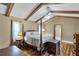 Main bedroom featuring hardwood floors, wood beams, and four poster bed at 526 Sabal Trail Cir, Longwood, FL 32779