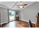 Bright office featuring hardwood floors, a ceiling fan and views from the large window at 526 Sabal Trail Cir, Longwood, FL 32779