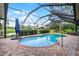Screened pool area with brick patio, view of the water, and landscaping at 526 Sabal Trail Cir, Longwood, FL 32779