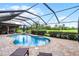 Home's screened pool area, including a brick patio, lounge chairs, and view of the green at 526 Sabal Trail Cir, Longwood, FL 32779