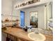 Spacious bathroom featuring a large mirror, wood countertop, and multiple storage shelves at 5395 Vineland Rd # S, Orlando, FL 32811