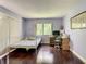 Cozy bedroom with hardwood floors, a large window, and a comfortable bed with neutral decor at 5395 Vineland Rd # S, Orlando, FL 32811