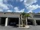 Charming condo featuring private covered parking, well-maintained landscaping, and convenient stair access at 5395 Vineland Rd # S, Orlando, FL 32811