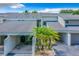 Inviting townhouse with a covered parking space and well-maintained landscaping featuring small palm trees at 5395 Vineland Rd # S, Orlando, FL 32811