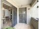 Enclosed patio with tile flooring, security door, and sliding glass doors leading to the interior at 5395 Vineland Rd # S, Orlando, FL 32811