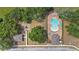 An overhead view of a pristine community pool and adjacent playground surrounded by green trees and shrubbery at 5639 Timber Meadow Way, St Cloud, FL 34771