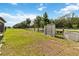 Fenced backyard features ample lawn space, lush trees, and functional storage sheds at 5639 Timber Meadow Way, St Cloud, FL 34771