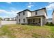 A spacious backyard featuring green grass, white fencing, and a covered lanai for outdoor relaxation at 5639 Timber Meadow Way, St Cloud, FL 34771