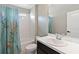 Bathroom boasts a white vanity, toilet, tub, shower with blue dragonfly curtain, and a large mirror at 5639 Timber Meadow Way, St Cloud, FL 34771