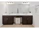 Spacious bathroom with double vanity, dark cabinets, large mirror, and glass-enclosed shower at 5639 Timber Meadow Way, St Cloud, FL 34771