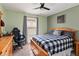 Bedroom features a ceiling fan, window, wooden bed frame, and gray and white bedding at 5639 Timber Meadow Way, St Cloud, FL 34771