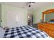 Bedroom showing double closets, open interior door, and wooden furniture with a black and white checkered bedspread at 5639 Timber Meadow Way, St Cloud, FL 34771