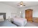 Shared bedroom with two beds, wood armoire, and adjoining door with partial view of bathroom at 5639 Timber Meadow Way, St Cloud, FL 34771