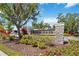 Stone entrance sign for Wiregrass community, surrounded by colorful landscaping at 5639 Timber Meadow Way, St Cloud, FL 34771
