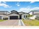 Inviting home exterior with brick driveway and beautifully landscaped front yard at 5639 Timber Meadow Way, St Cloud, FL 34771