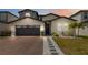 Beautiful home exterior with a brick driveway and manicured landscaping at 5639 Timber Meadow Way, St Cloud, FL 34771