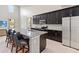 Modern kitchen with granite countertops and dark cabinets at 5639 Timber Meadow Way, St Cloud, FL 34771