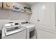 Laundry room featuring a washer and dryer, storage shelf, and utility closet with white walls at 5639 Timber Meadow Way, St Cloud, FL 34771