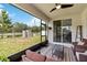 Covered outdoor patio featuring patio furniture, a ceiling fan, and scenic views of the backyard at 5639 Timber Meadow Way, St Cloud, FL 34771