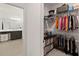Walk-in closet with clothing racks and shelving, attached to bright bathroom with double vanity at 5639 Timber Meadow Way, St Cloud, FL 34771