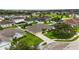 Aerial view of a single-Gathering home that features a well-manicured lawn, two-car garage and landscaping at 6005 Coal Ct, St Cloud, FL 34772