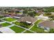 Aerial view of a spacious backyard with white fence, screened-in porch, and beautiful landscaping at 6005 Coal Ct, St Cloud, FL 34772