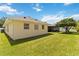 Exterior view of home, showcasing backyard and screened-in lanai at 6005 Coal Ct, St Cloud, FL 34772