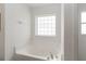 Bathroom features a soaking tub with a window at 6005 Coal Ct, St Cloud, FL 34772