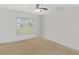 Unfurnished bedroom with neutral carpet and large window offering a view at 6005 Coal Ct, St Cloud, FL 34772