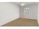 Clean bedroom with neutral carpet, ceiling fan, and a bright window at 6005 Coal Ct, St Cloud, FL 34772
