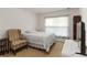 Bright bedroom with an armchair, a single bed, and carpet flooring at 6005 Coal Ct, St Cloud, FL 34772