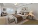 Stylishly staged bedroom with king bed, chair, and complementing decor at 6005 Coal Ct, St Cloud, FL 34772