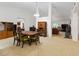 Open-concept dining room featuring a chandelier, classic furnishings, and views into adjacent living spaces at 6005 Coal Ct, St Cloud, FL 34772