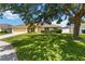 Inviting single-story home with a well-maintained lawn, sidewalk, and mature trees providing shade at 6005 Coal Ct, St Cloud, FL 34772