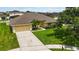 Charming single-Gathering home with a well-manicured lawn, two-car garage and lovely landscaping at 6005 Coal Ct, St Cloud, FL 34772
