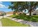 Inviting single-story home with a well-maintained lawn, sidewalk, and mature trees providing shade at 6005 Coal Ct, St Cloud, FL 34772