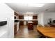 Open kitchen features white appliances, wood cabinets, and center island at 6005 Coal Ct, St Cloud, FL 34772