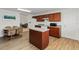 Efficient kitchen has wood cabinetry, a center island, and updated appliances at 6005 Coal Ct, St Cloud, FL 34772