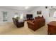 Comfortable living room with vaulted ceiling, fan, and neutral carpet features leather furniture at 6005 Coal Ct, St Cloud, FL 34772