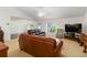Bright living room boasts vaulted ceilings, neutral carpet, and large windows at 6005 Coal Ct, St Cloud, FL 34772