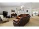 Spacious living room features vaulted ceilings, neutral carpeting, and comfortable seating at 6005 Coal Ct, St Cloud, FL 34772
